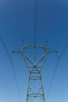 Detail of electricity pylon against blue sky 