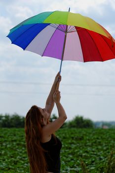 beautiful young girl with rainbow colored umbrella