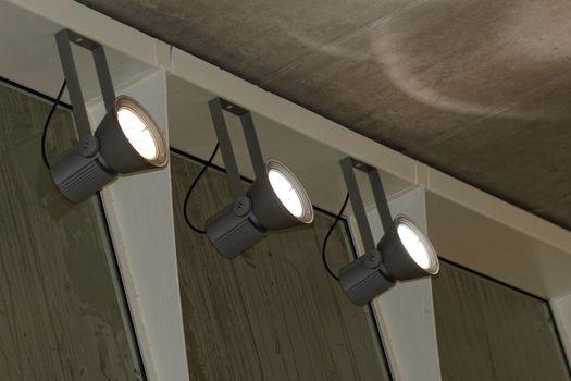 industrial lights on the wall inside a building