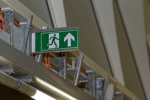 Emergency exit sign in construction site an industrial plant