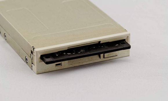 Floppy disk drive and diskette on white background