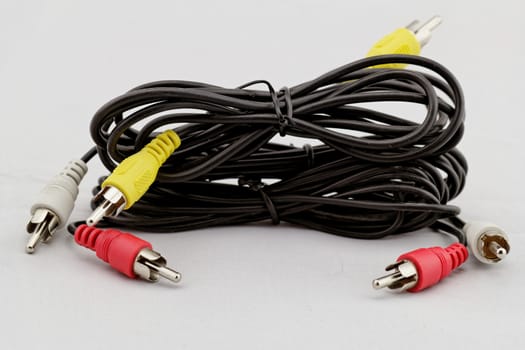 three audio (left - right) - video RCA cable and plug (red, white, yellow) on white background