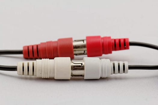 correct conection between left - right audio RCA cable on a white background (red white)