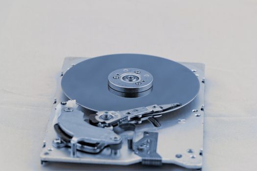 Open computer hard drive on white background with blue (HDD, Winchester)