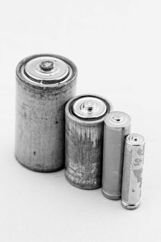 Old grey batteries on white background (aa, aaa, b, c)