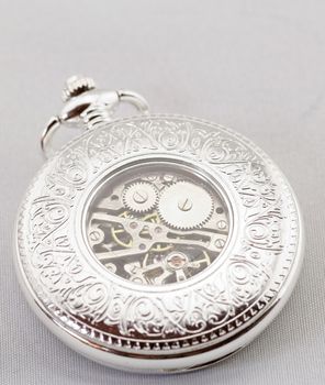 Part of a antique mechanical pocket watch on white background