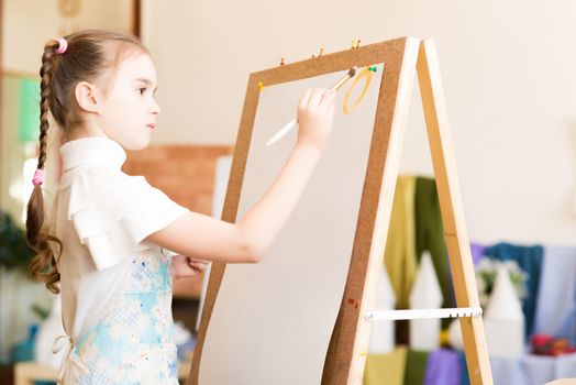 portrait of a girl standing next to his easel, a drawing lesson