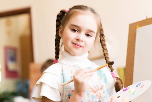 portrait of a girl standing next to his easel, a drawing lesson