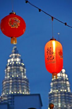 Lit Chinese Lanterns during the festive season in Kuala Lumpur, Malaysia with Patronas towers in the background.