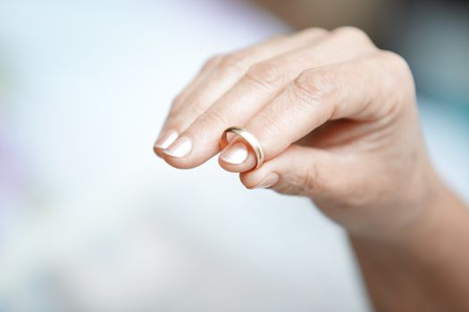 Hand of senior woman holding engagement ring