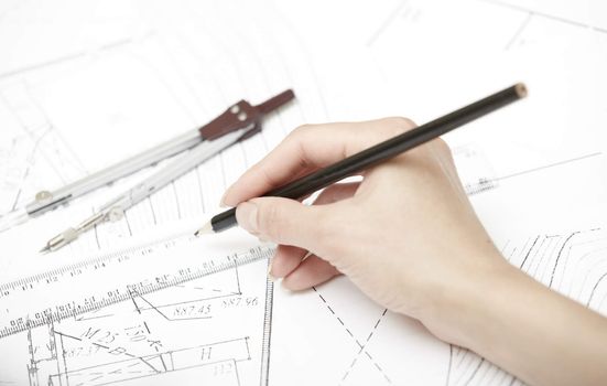 Hand of engineer working on a construction plan