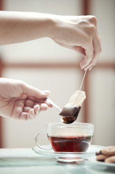 Human hands making tea 