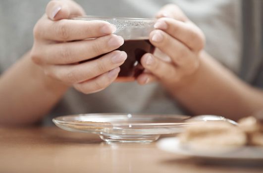 Human hands holding cup of tea