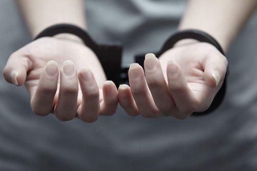 Human hands in handcuffs. Close-up horizontal view