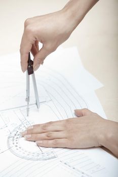 Hands of engineer working on a construction plan