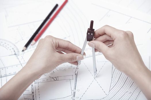 Hands of engineer working on a construction plan