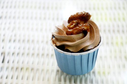 Cupcake with caramel walnut on table