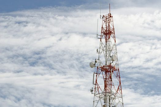 Telecommunication mast with microwave link and TV transmitter antennas over a blue sky