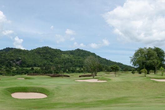 Bunker on golf course under the blue sky