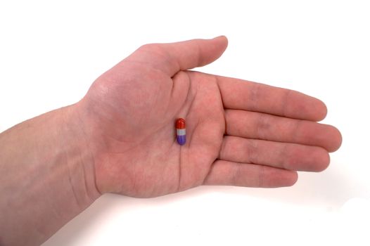 Red and Purple Pill in the palm of caucasian male hand.