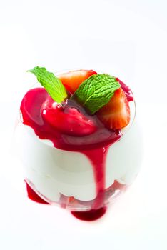 Sweet dessert strawberry and cream in a glass on white background