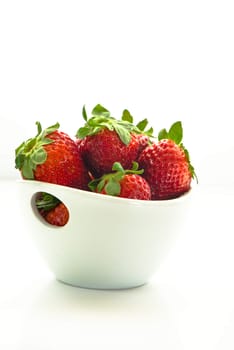 a bowl with fresh strawberries on white background