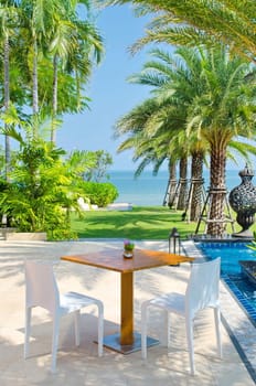 Coffee table in a garden next to the beach