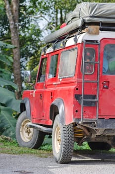 red adventure car in the forest