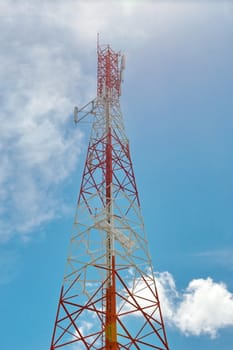 Telecommunication mast with microwave link and TV transmitter antennas over a blue sky