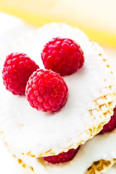 small raspberry cake with cream on white background