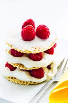 small raspberry cake with cream on white background