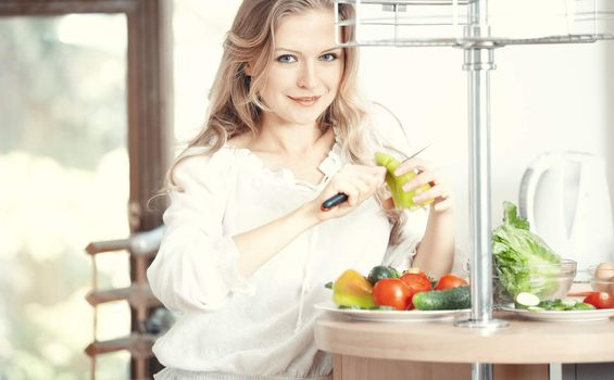 Blond lady at kitchen preparing vegetable for breakfast