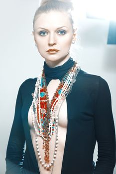 Stylish lady in studio with luxurious jewelry