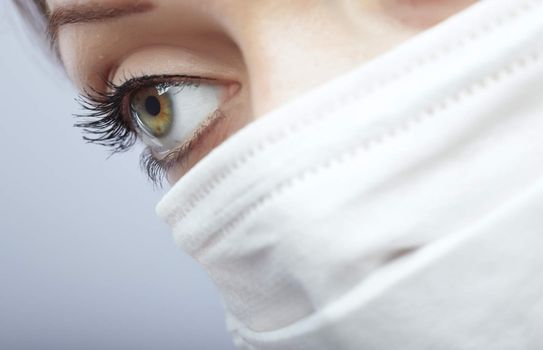 Close-up photo of the woman face protected by the face mask