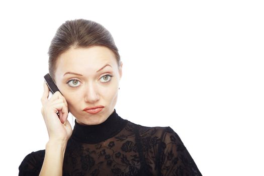 Displeased lady talking by cell phone on a white background