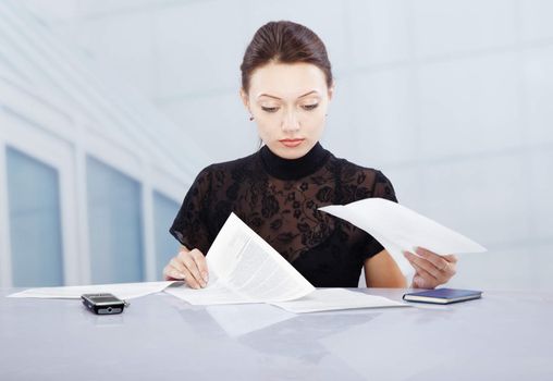 Young businesswoman in office working with documents