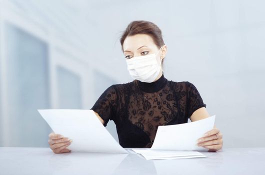 Woman at work with protective mask against influenza virus