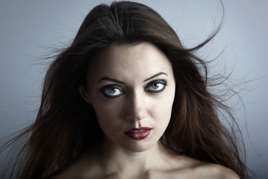 Portrait of the woman with Gothic makeup and blown hairs