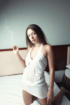 Woman with cigarette at home