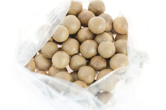 top view macadamia in plastic bag on white background