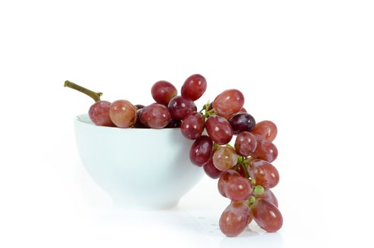 ripe grapes  fruits in white bowl  over white background