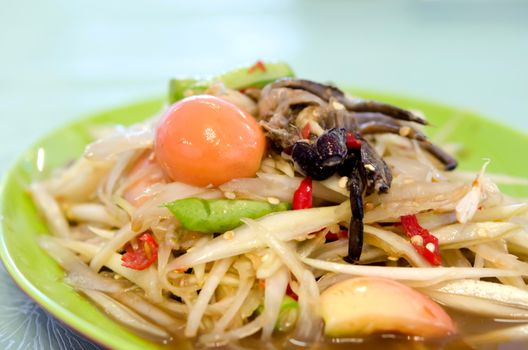 thai papaya salad on green dish , spicy dish