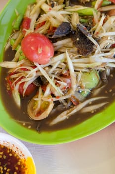 top view asian food on table , spicy  papaya salad and spicy chili sauce