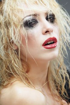 Beautiful blond lady with strange makeup. Artistic colors added
