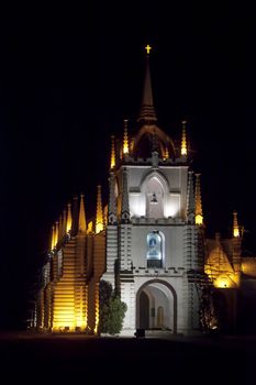 Vertical portrait of Mae de Dues Church Goa India taken from the public road surrounding the property, generic night scene of the Portuguese inspired religious architecture