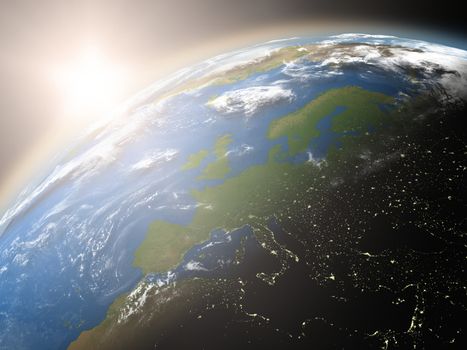 Space view of the sun rising over Europe on planet Earth. Elements of this image furnished by NASA.