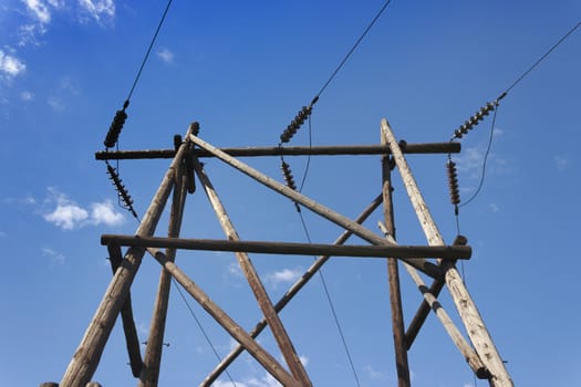 Wooden pillar of electricity transmission line against the sky