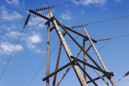 Wooden pillar of electricity transmission line against the sky