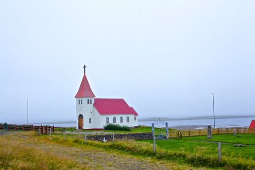 Small white church near the ocean, Iceland. Summer day.