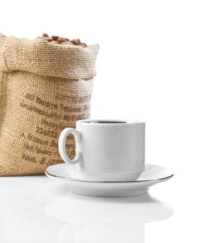 white cup and sack with beans